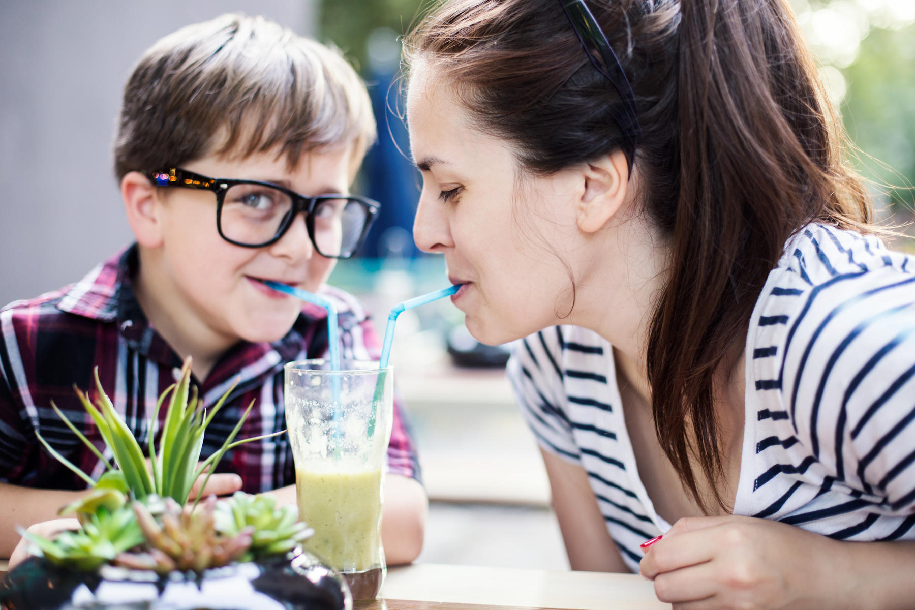 Mother and son drinking a smoothie