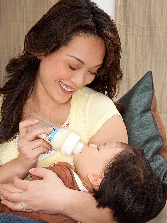 mother bottle feeding baby