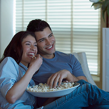 Couple watching movie on couch