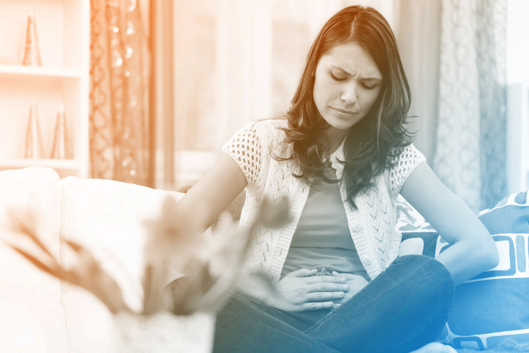 woman holding abdomen like she has painful cramps