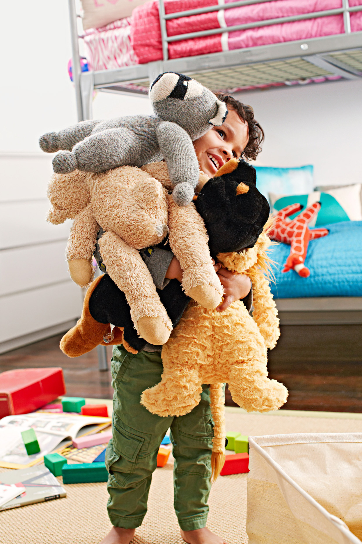 child holding stuffed toys