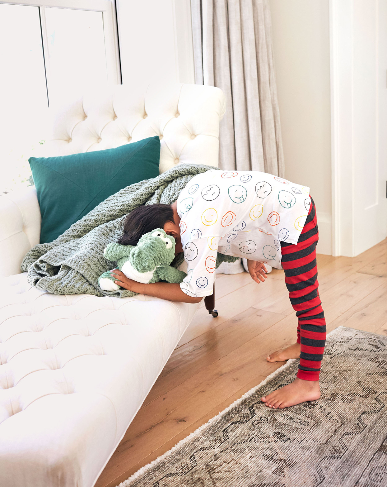 child with face in couch