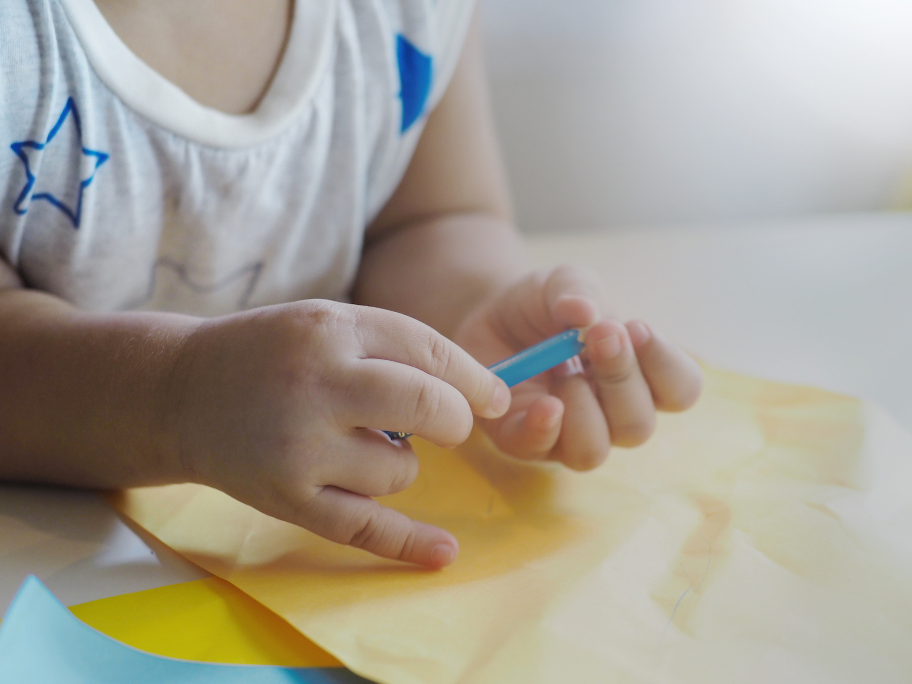 toddler hands holding pencil