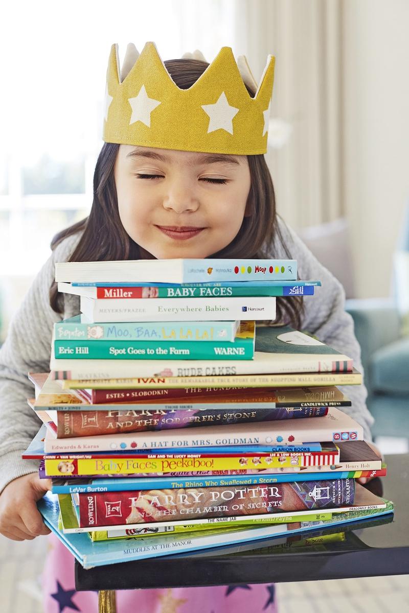 Encourage Empathy Girl Holding Stack of Books