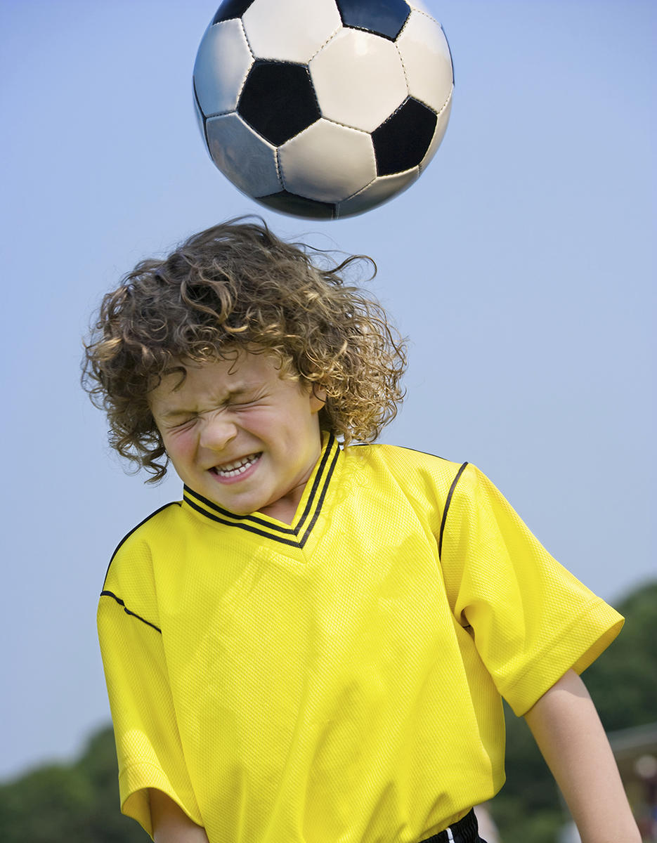 boy heading soccer ball