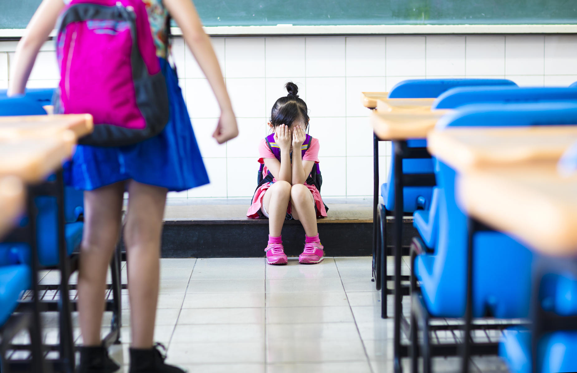 Little girl being bullied in classroom