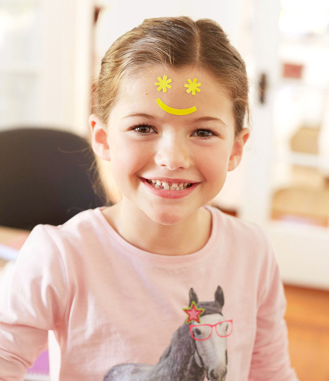 child with smiley face on forehead