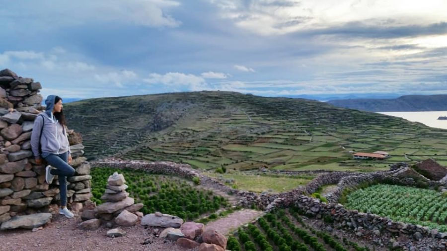 Sahara Rose De Vore overlooking a lush green hilly landscape